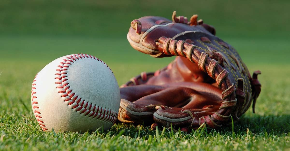 Baseball glove with ball on grass