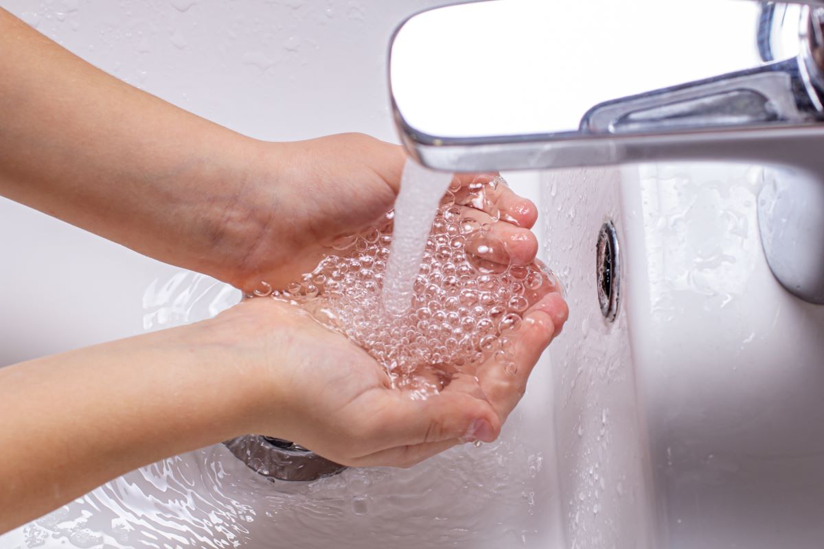 hands being washed in warm water from on-demand water heater