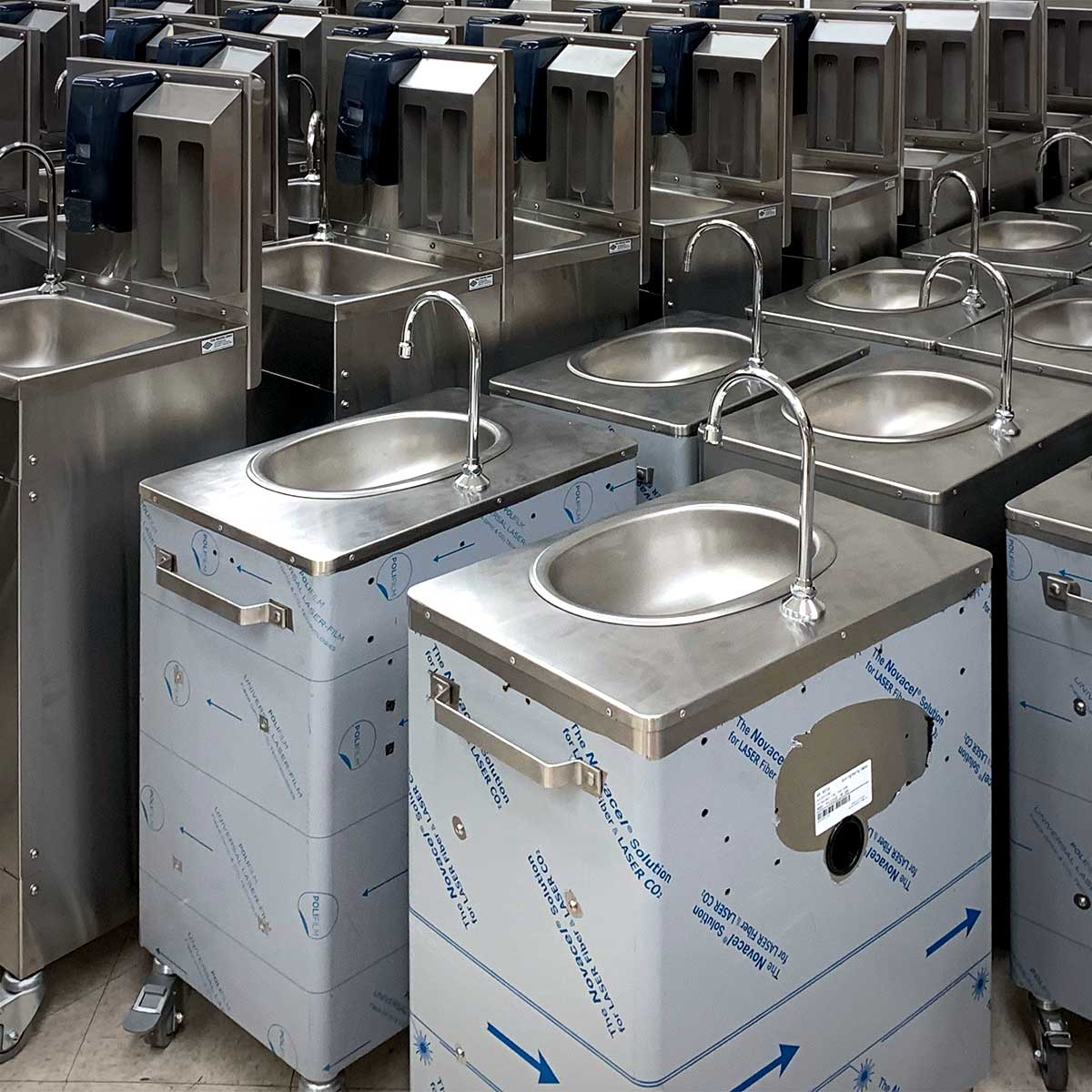 Assembled and partially assembled portable sinks