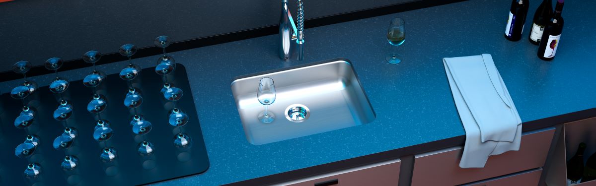 Acorn-Sinks® stainless steel commercial sink with an empty wine glass in the basin